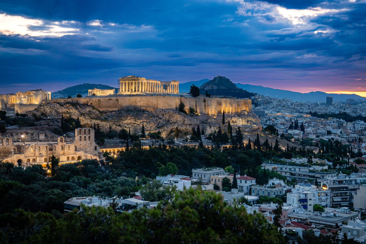 The Acropolis of Athens lit at daybreak above the city.