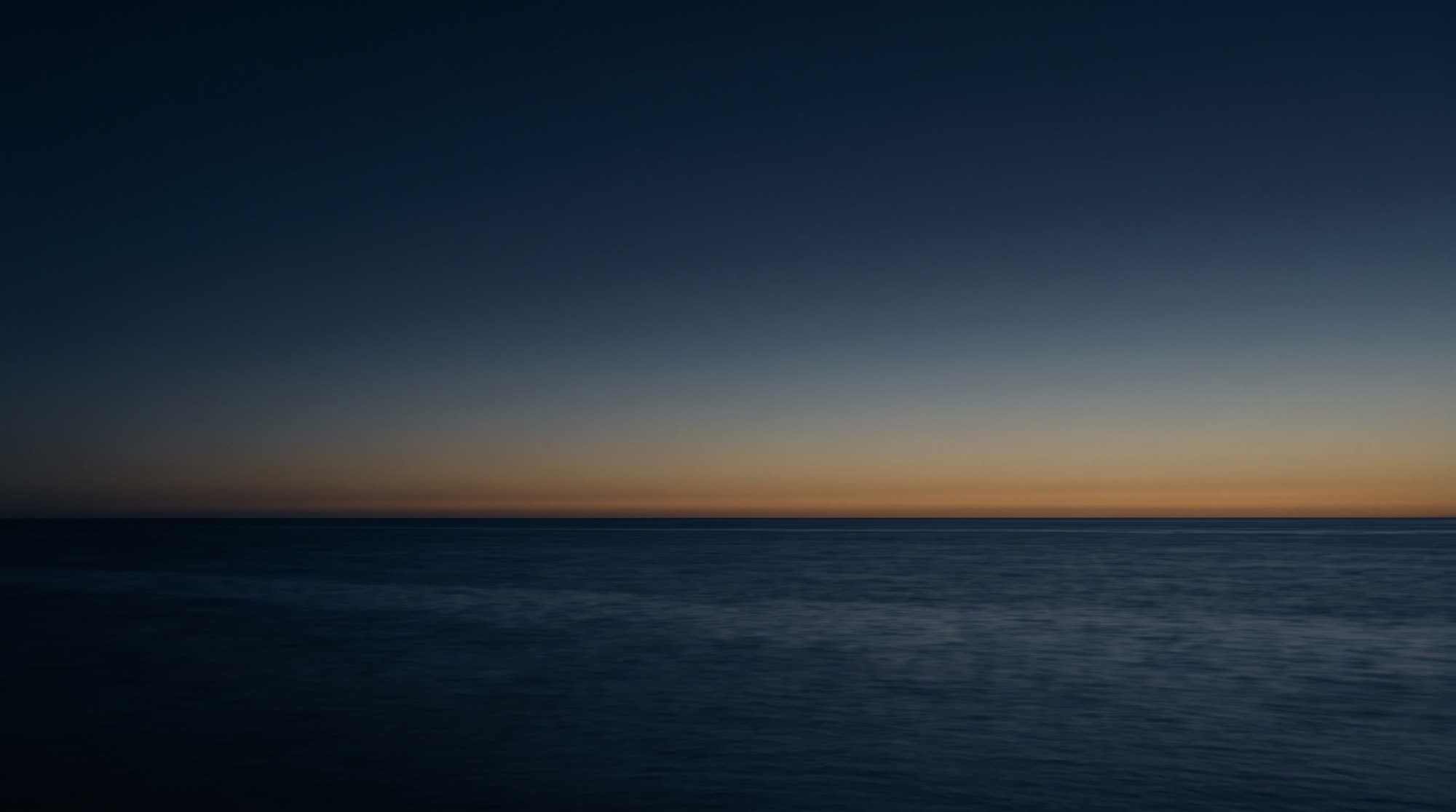 The open Aegean at dusk, seen from the deck of a yacht.